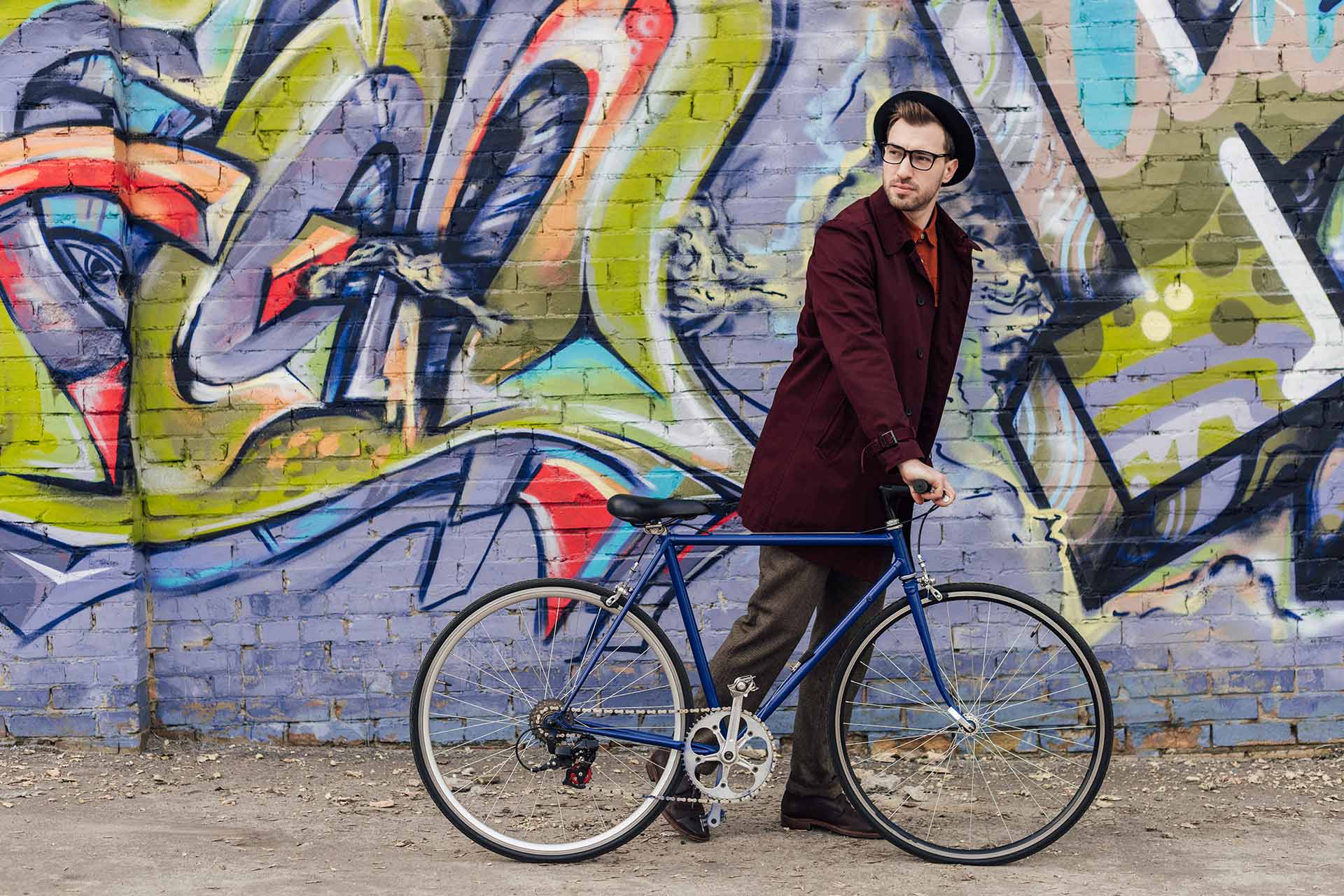 stylish-elegant-man-standing-with-bike-at-wall-wit-56WQDMB